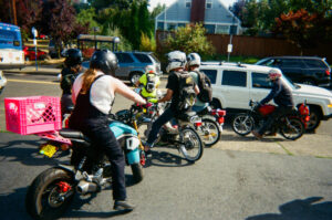 A group of six people on small motorbikes